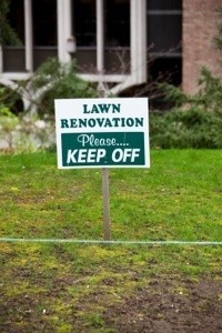 Recently seeded lawn with a keep off sign.