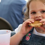 A girl eating a cookie.