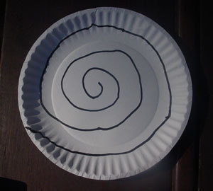 A spiral twirler for decoration, made from a paper plate.