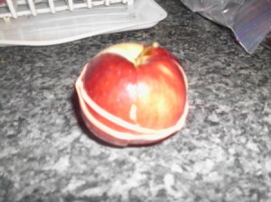 A cut apple that is held together with a rubberband to keep from browning.