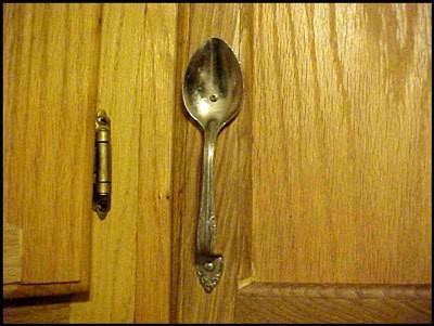 A cabinet with a spoon as hardware.