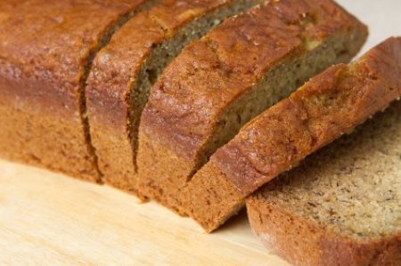 Sliced banana bread on a cutting board.