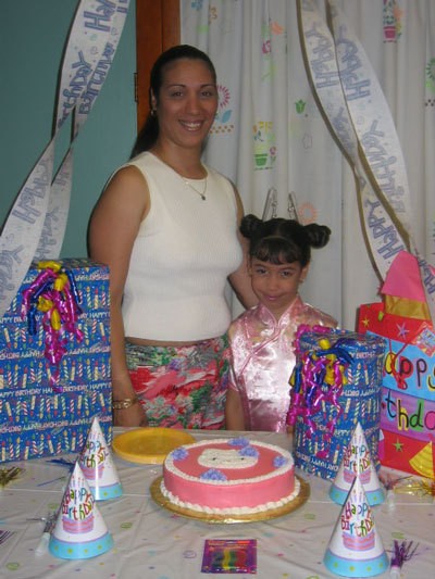 A mom and daughter with a cake decorated with Hello Kitty.