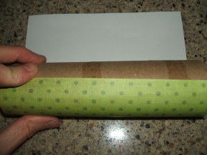 Rolling paper onto tube.