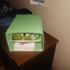 Cereal box storage covered with green and white fabric