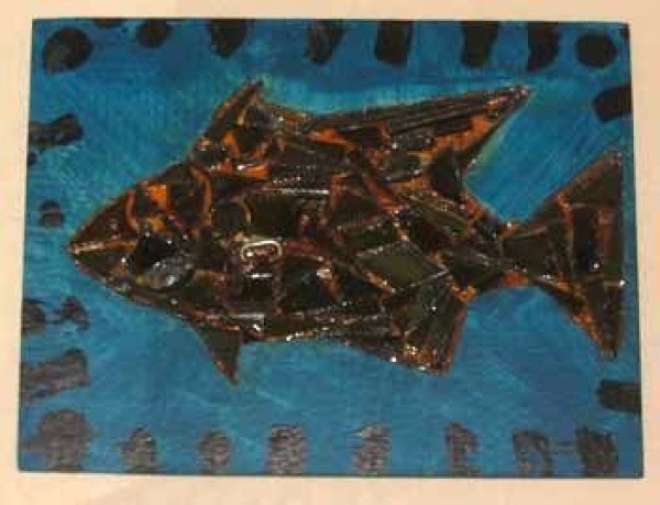 Scrap metal fish collage on wood.