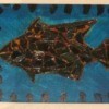 Scrap metal fish collage on wood.