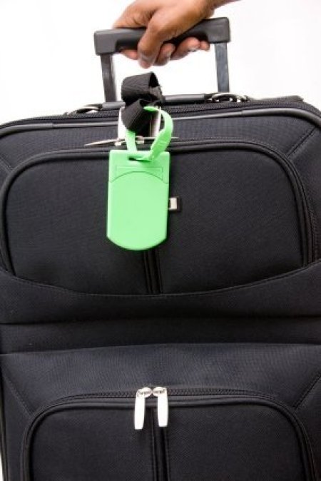Generic black suitcase with bright green tag.