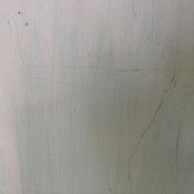 Green resudue on plaster under old wallpaper.