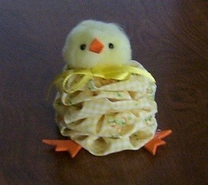 A cute chick made from fabric yo-yos.