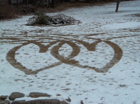 Two hearts caused by tire tracks in the snow.