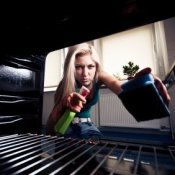 Keeping Your Oven Clean, Young Woman Cleaning her Oven