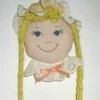 Hair accessory doll hanging on wall.