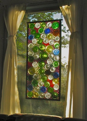 A stained glass window using cut wine bottle bottoms.