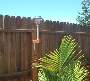 Attach Solar Lights to Your Fence - Solar light attached to a fence post.