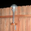 Attach Solar Lights to Your Fence - Solar light attached to a fence shown at night.