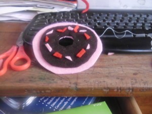 Sewing pieces of donut pin cushion together