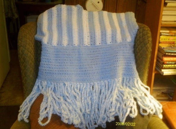 Crocheted Calypso Cardigan, back side displayed on a chair.