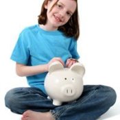 Young Girl Holding Piggy Bank