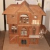 Front view of unfinished plywood doll house.