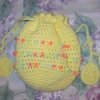 Crochet beaded Easter bag in yellow with pastel beads and egg shapes on ends of drawstrings.