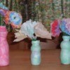 Drinkable yogurt bottle vases with paper flowers.