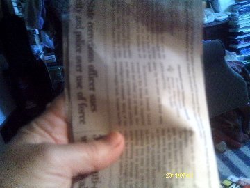 A piece of newspaper for making a seed pot.