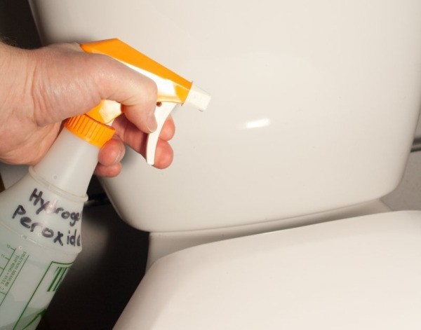 Spraying Hydrogen Peroxide on Toilet
