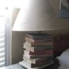 A lamp with stacked books as the base.