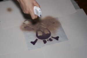 Using spray paint to cover the pirate girl template.