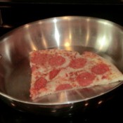 Slices of pizza in a frying pan