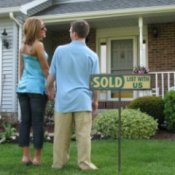 Couple Standing in Front of Their New House