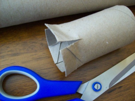 Cutting the paper towel tube.