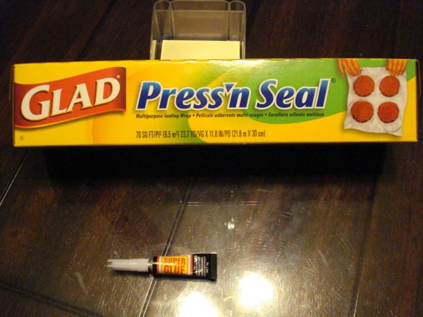 A box of Press'N Seal plastic wrap and a tube of super glue.