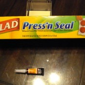 A box of Press'N Seal plastic wrap and a tube of super glue.