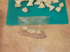 Adding pieces to cinnamon sugar in bag
