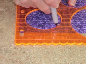 Tracing circle on fabric.