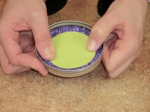 Scrapbook paper circle to cover gathered fabric on lid.