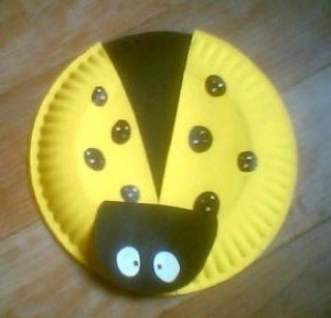 A ladybug kids craft made from a paper plate.