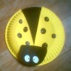 A ladybug kids craft made from a paper plate.