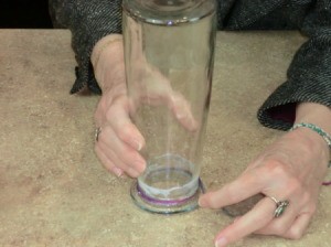 Wrapping yarn around vase.