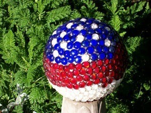 A patriotic garden ball in red, white and blue.
