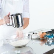 Woman Sifting Flour to Make Cookie Dough