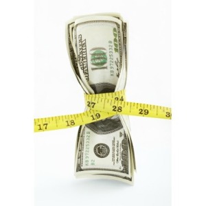 Money Being Cinched by Measuring Tape