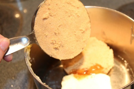 Adding brown sugar to pan with margarine, corn syrup, and salt