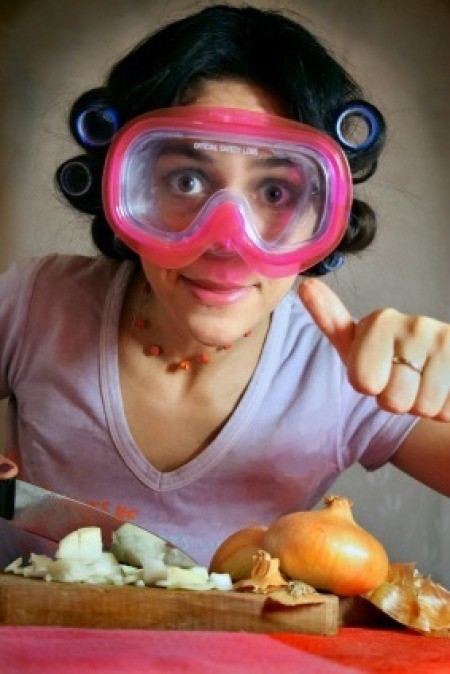 Wearing goggles while chopping onions.