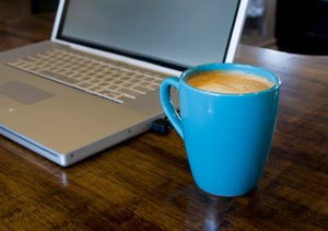 Cup of Coffee Next to Laptop