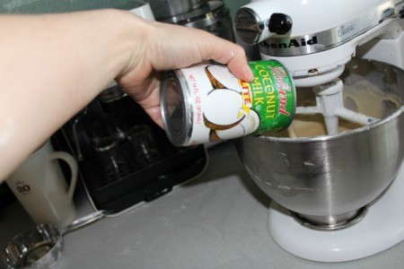 Light coconut milk being poured into mixing bowl