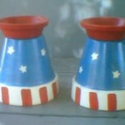 A pair of Fourth of July candle holders made from clay pots.
