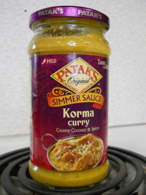 Curried chicken and rice, jar of Korma curry sauce